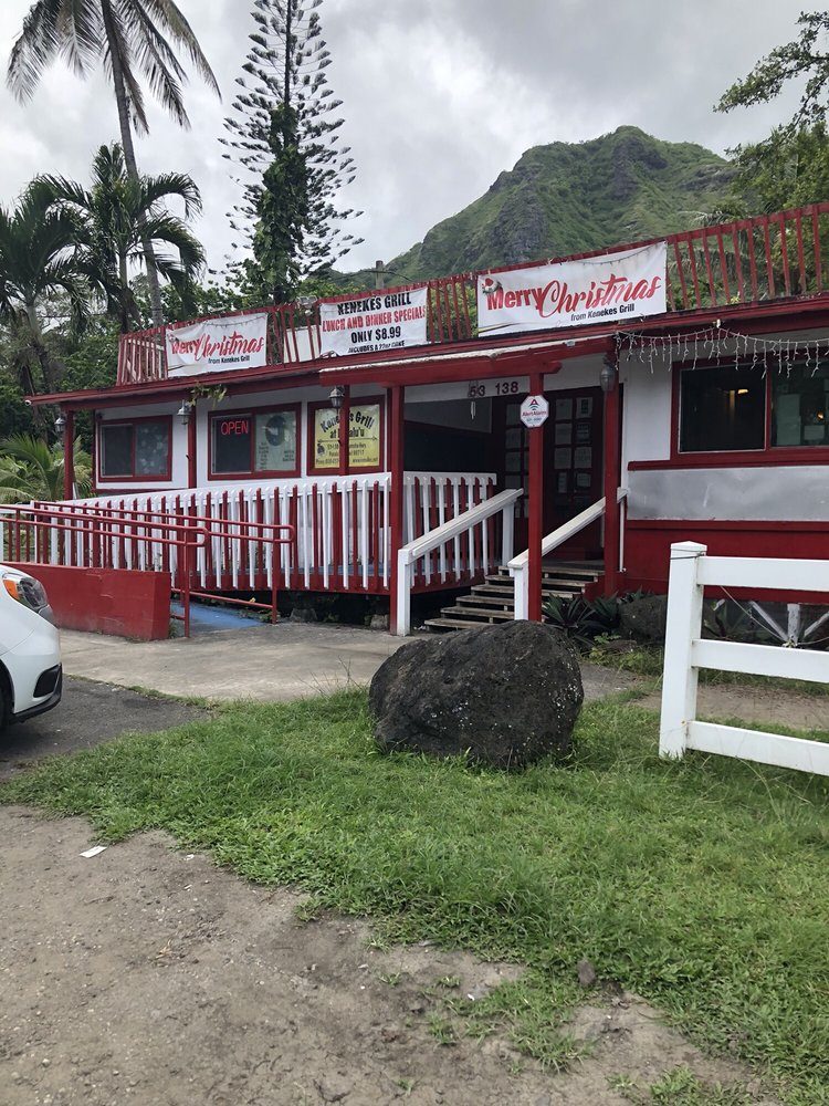 Keneke's Grill at Punaluʻu: red and white building with a covered lanai, mountains behind